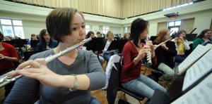 Music students play flutes and other instruments.