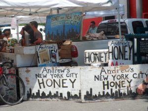 Beekeeper Andrew Cote advertises his honey for sale at the Union Square Greenmarket. (photo by Kate Grady)