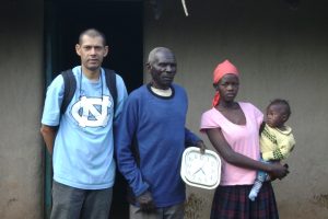 UNC Professor Sudhanshu Handa (far left) is pictured with a family in Western Kenya who benefits from the cash transfer program. The photo was taken during June 2011 during field work for the study. 