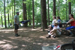 Mario Marzan (with stick in hand) explains the contour mapping assignment at the New Hope Overlook campsite. (photo by Kim Spurr)