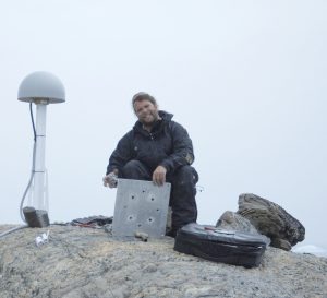 Mike Willis installing a Continuous GPS station at the Lynaes Peninsula in Eastern Greenland. The GPS is part of network designed to continuously weight the Greenland Ice Sheet. Photo by Thomas Nylen.