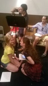 Margaret Burrus and Ashley Coia rehearse their illicit love scene as Jack Utrata conspicuously spies on them.