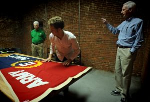 The Army Navy Efficiency Flag presented to Firestone mill. From left, former employee Bill Passmore, Ph.D. student Elijah Gaddis and Digital Innovation Lab director Bobby Allen. Views of a tour by UNC-Chapel Hill faculty and students of the Loray Mill project in Gastonia, NC.