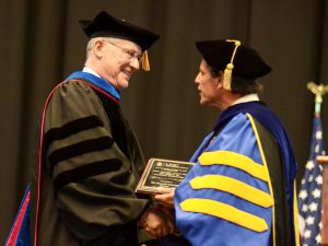 Donald J. Raleigh (left) receiving the Faculty Award for Excellence in Doctoral Mentoring from Graduate School Dean Steve Matson.