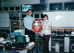 Pozefsky and Hiroshi Takayasu, then-manager of the IBM Japan Olympics Networking team, hold a Daruma Doll — a Japanese good luck symbol for success that keeps people focused on their goal. This doll, in particular, was a symbol for the success of the Olympics. (photo courtesy of Diane Pozefsky)