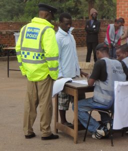 Police monitor the voting.