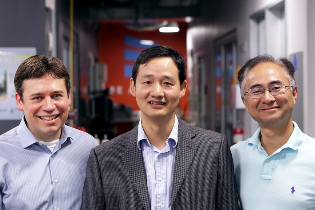Jinsong Huang, center, with UNC colleagues Jim Cahoon (left) and Wei You. (photo by Lars Sahl)