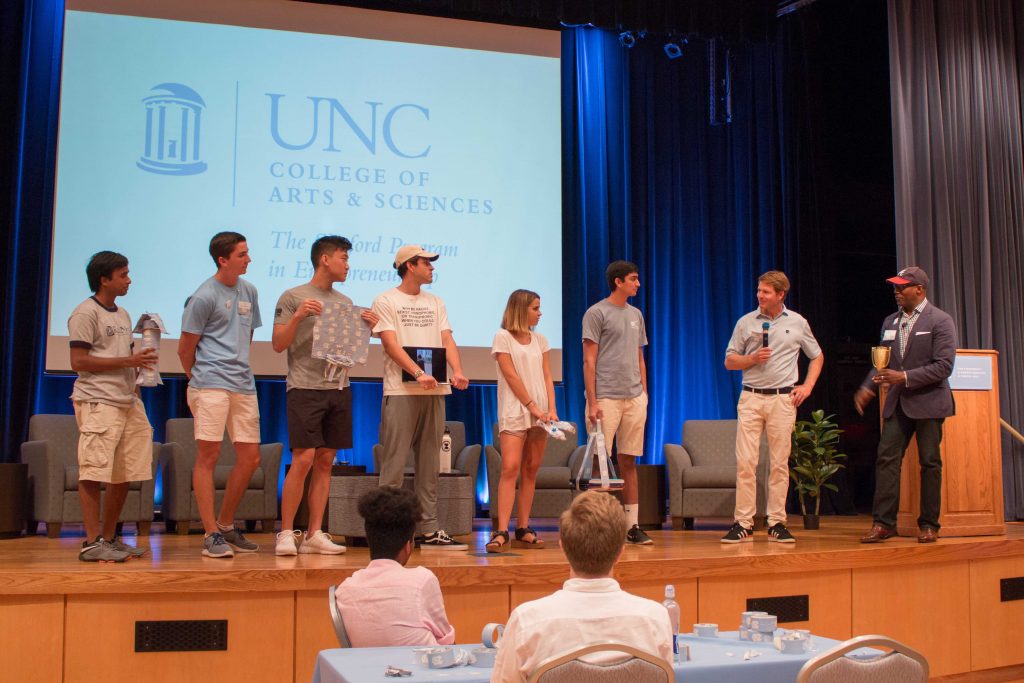 The contestants for the Duck Tape innovation challenge stand on stage and shows off their creations.