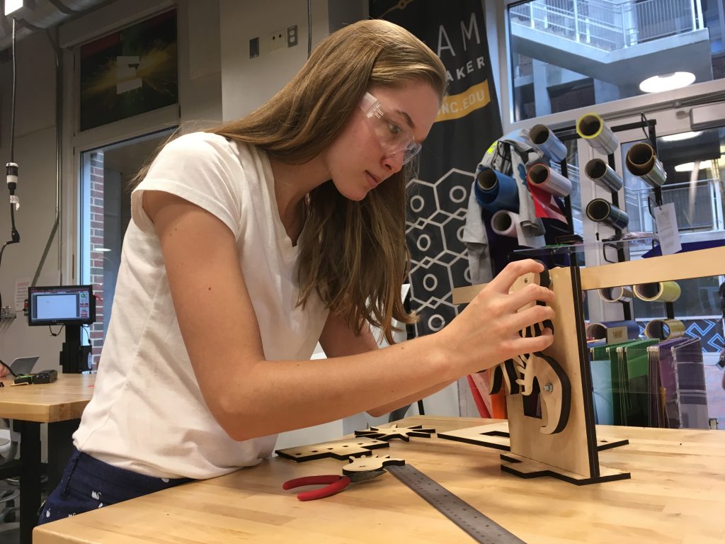 Student Molly Dwyer creates a clock escapement for her physics course, “How Things Work,” developed with QEP funding. (she is working in a campus makerspace)