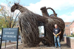 Patrick Dougherty's latest stick sculpture at the Ackland Art Museum is called "Step Right Up." (Dougherty stands in front of the giant stick sculpture)
